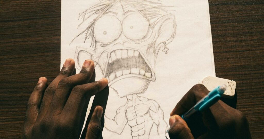 Hand sketching a wide-eyed cartoon character in pencil on paper